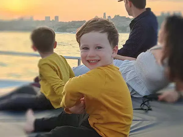 Family on a yacht deck at sunset on the Bosphorus