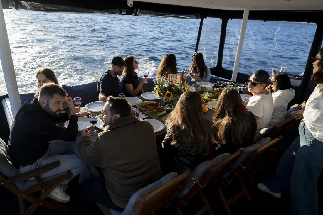 Group lunch on the covered deck of a yacht on the way to Anadolu Kavağı