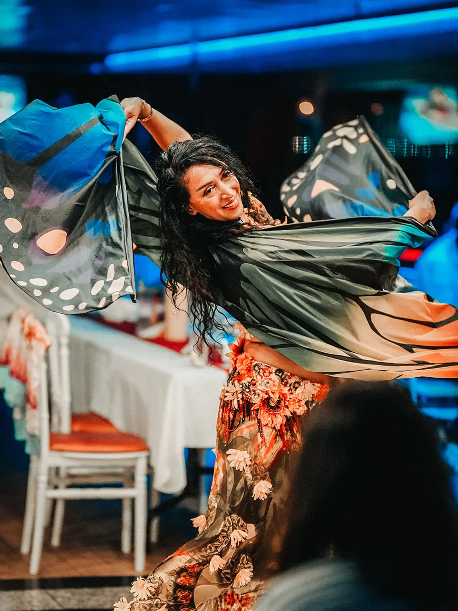 Belly dancer performing for guests on the dinner cruise