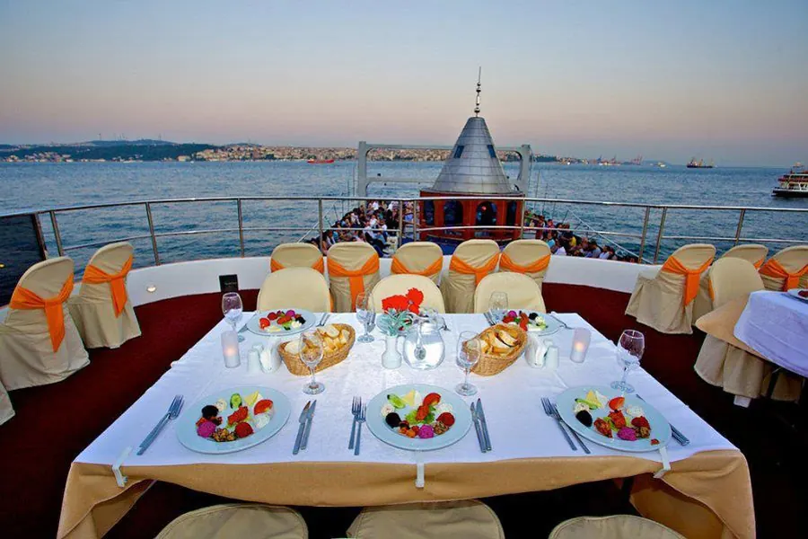 VIP table on the top deck of the dinner cruise boat at dusk