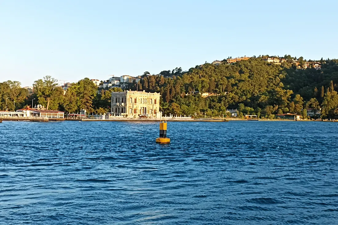 White waterfront mansion among the trees on the Bosphorus