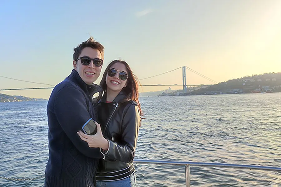 Couple on the sunset cruise with the Bosphorus Bridge in the evening light