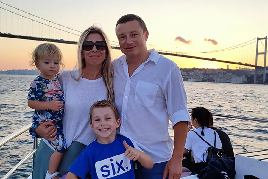 Couple with wine on a sunset yacht