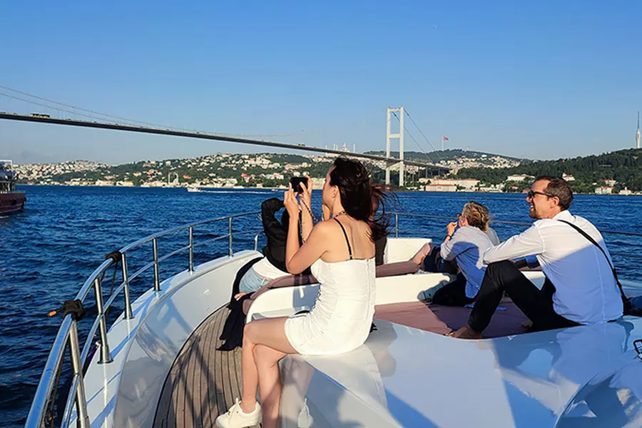 Guests photographing the sunset from a yacht