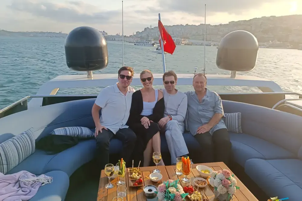 Friends with drinks on a private yacht on the Bosphorus