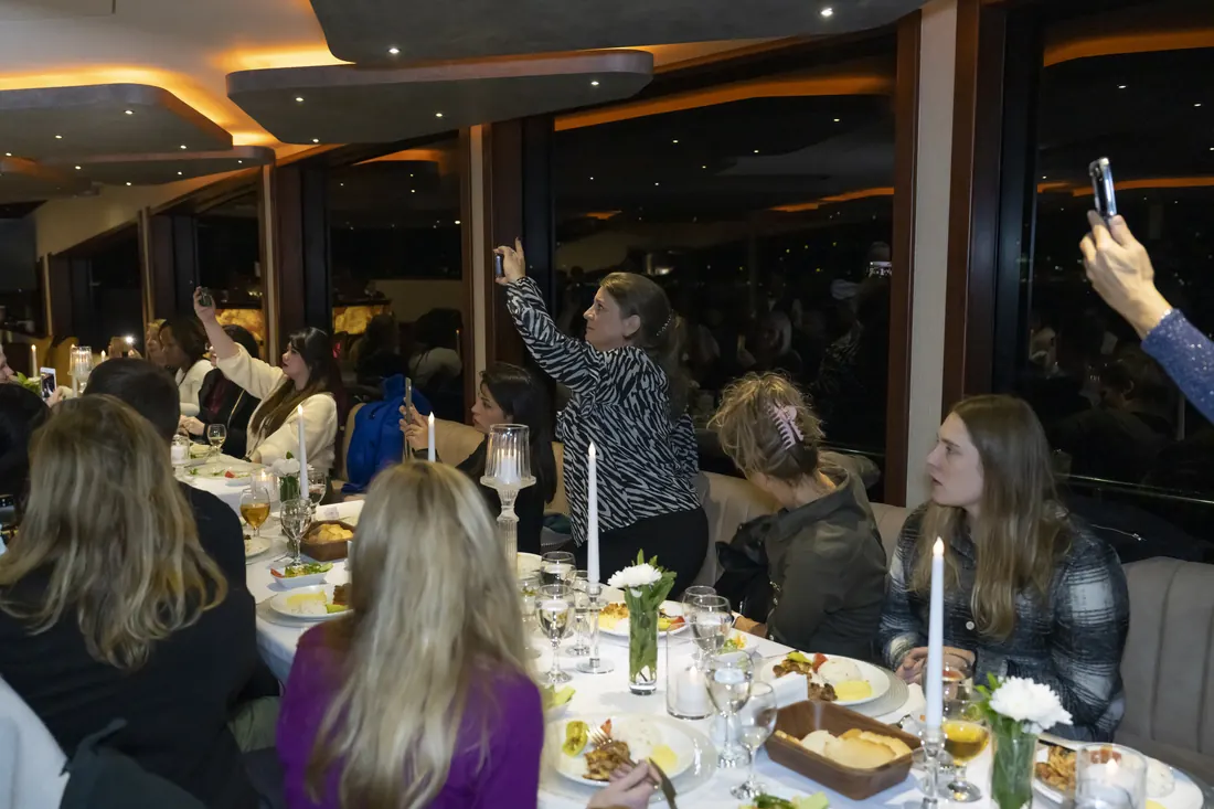 Guests at a gala dinner on a yacht in Istanbul