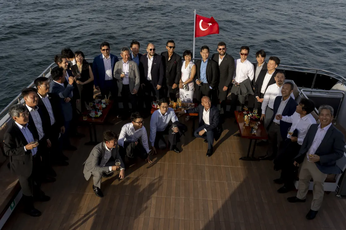 Corporate group on the bow of a yacht