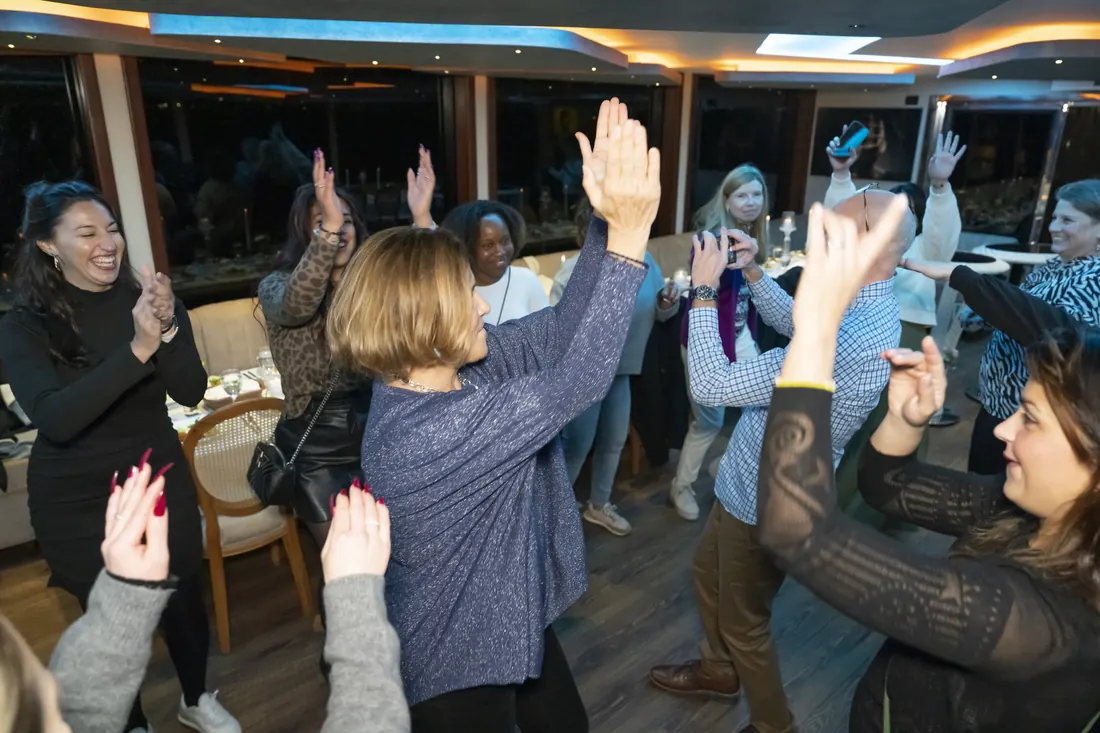 Guests dancing at a company party on a yacht
