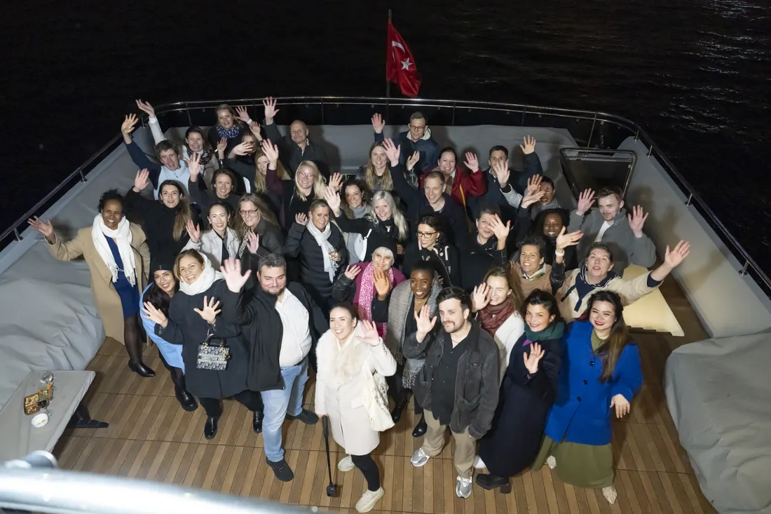 Large company group celebrating on a yacht at night