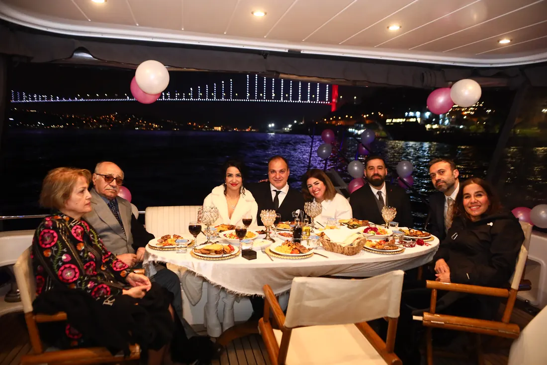 Family table with balloons on a yacht at night