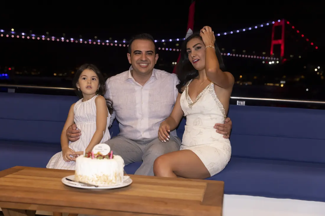 Little girl with a cake on a yacht at night
