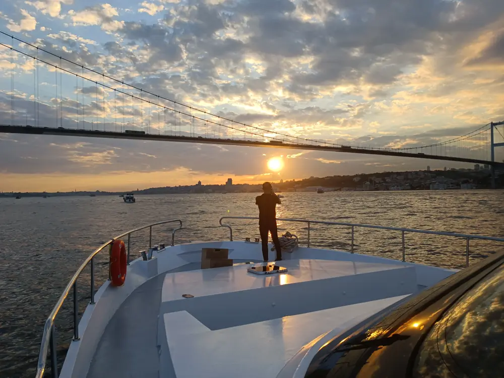 Sunset under the Bosphorus Bridge seen from the bow of a private yacht