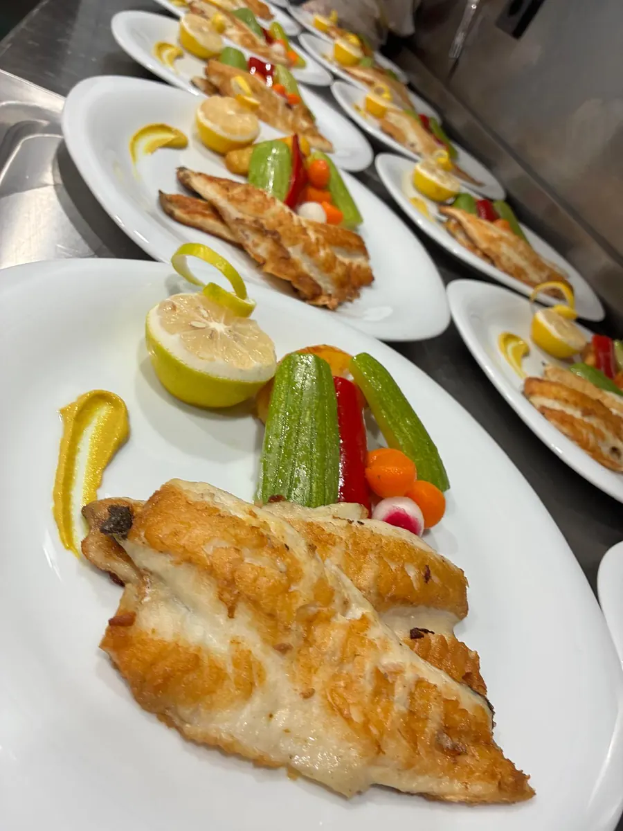 Grilled sea bass served for lunch on a yacht