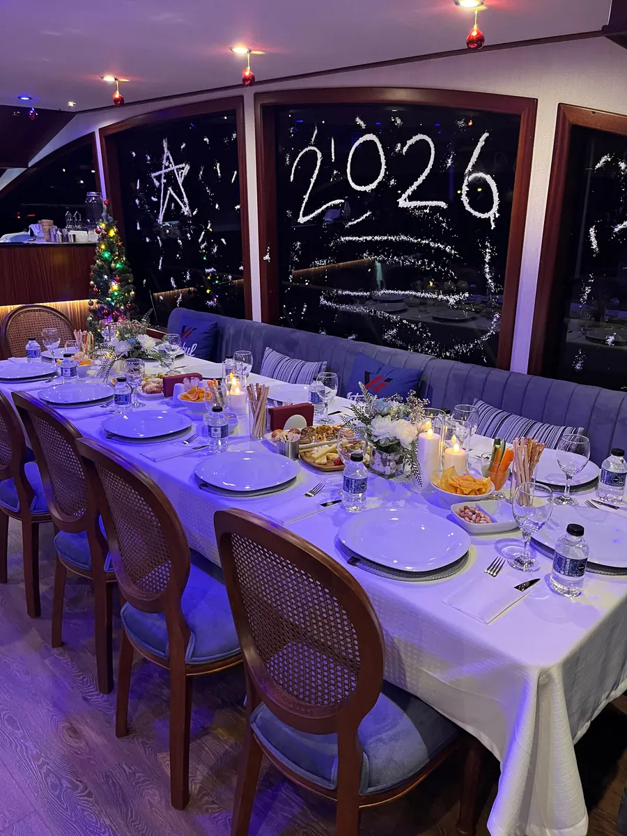 Tables set for New Year's Eve in a yacht saloon