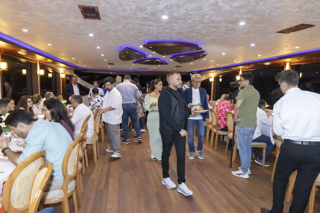 Guests mingling in the saloon of an event yacht