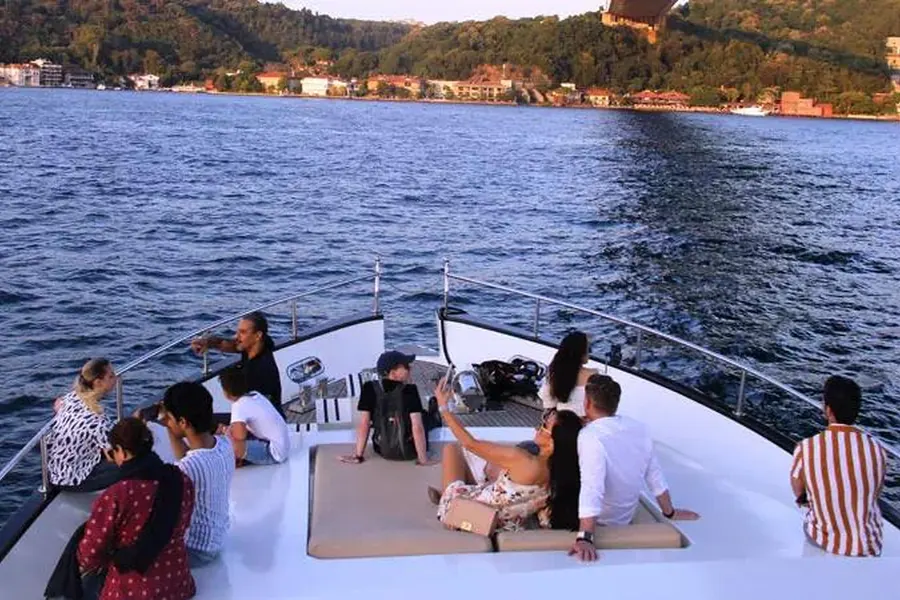 Friends relaxing on the yacht deck in the evening