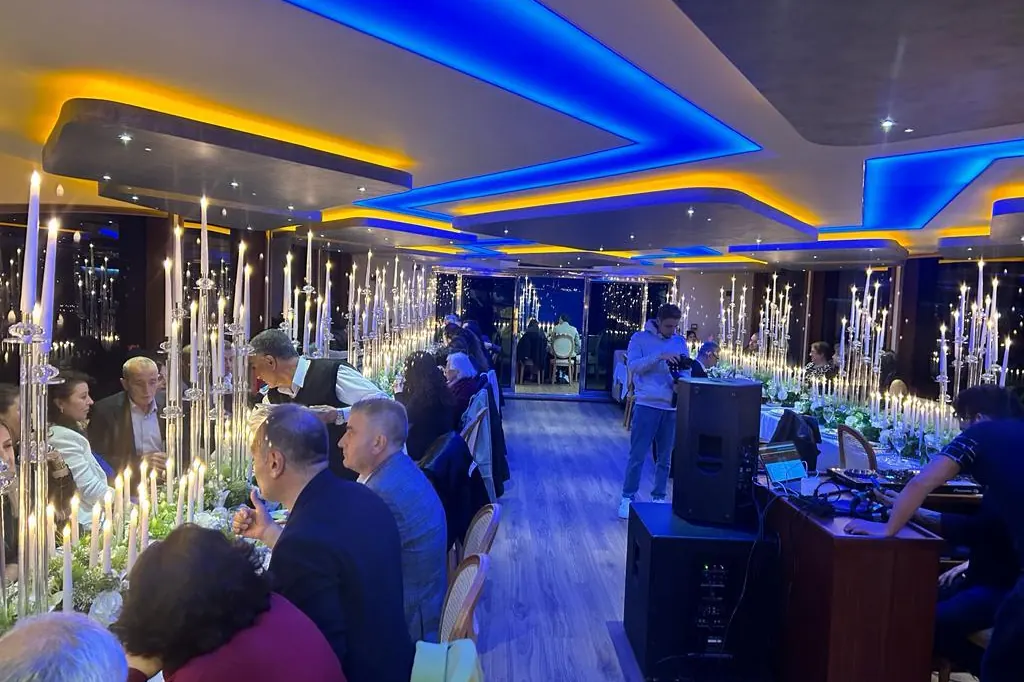 Wedding reception with candles in a yacht saloon