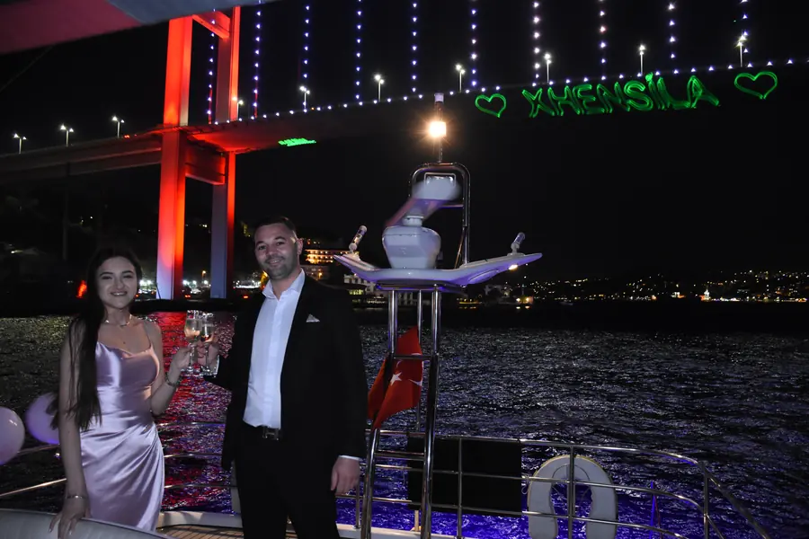 Laser hearts projected near the Bosphorus Bridge during a yacht celebration