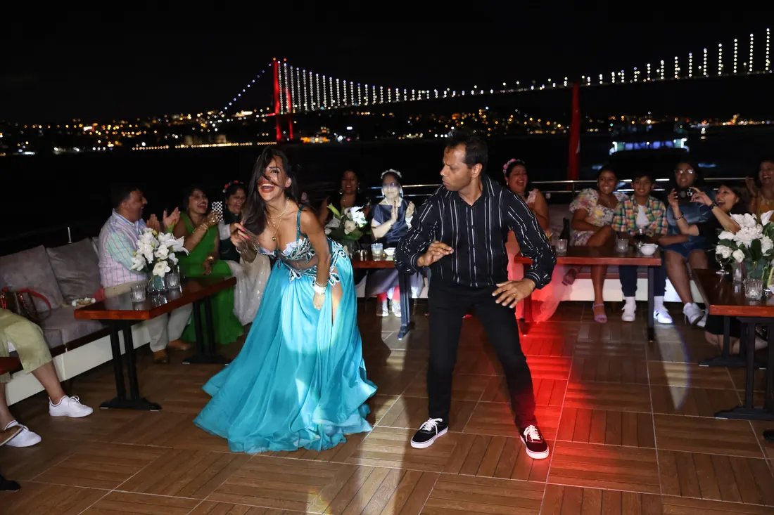 Guests dancing at a celebration on a yacht at night