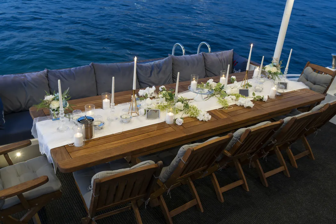 Wedding table with white flowers on a yacht deck