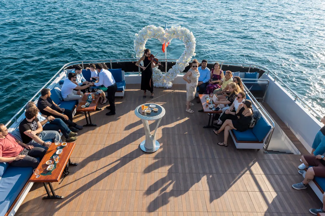 Engagement party with a heart flower arch on a yacht